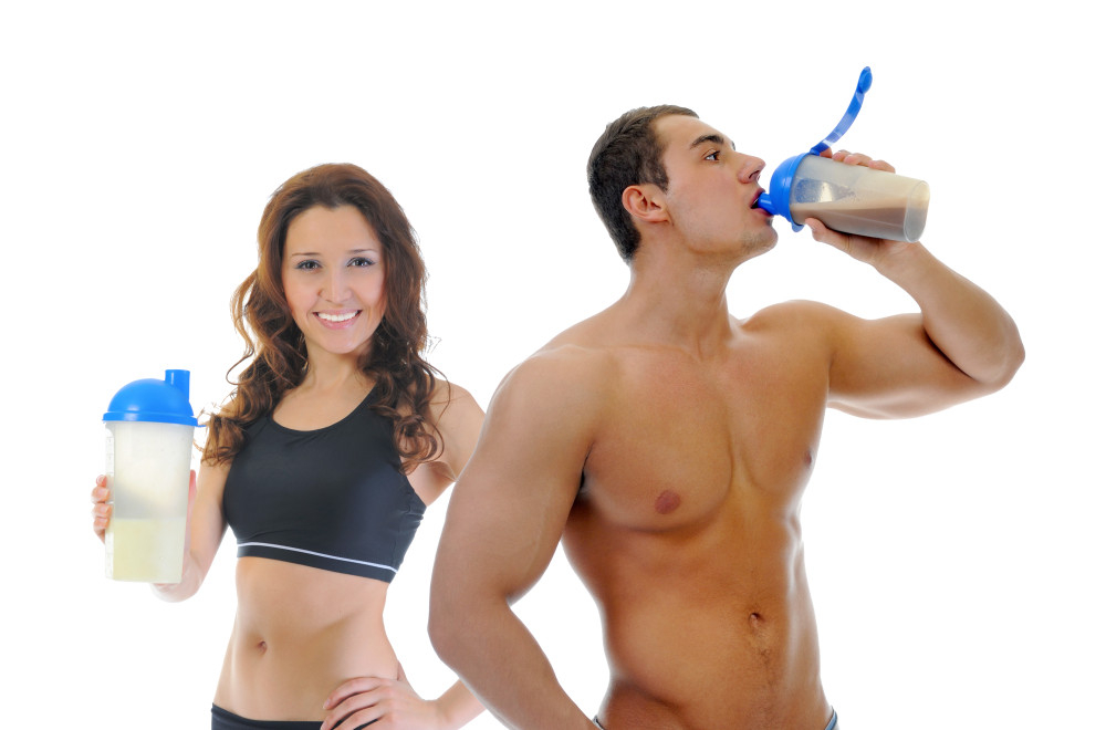Athletic young man and woman with protein shake bottle. Isolated on white background